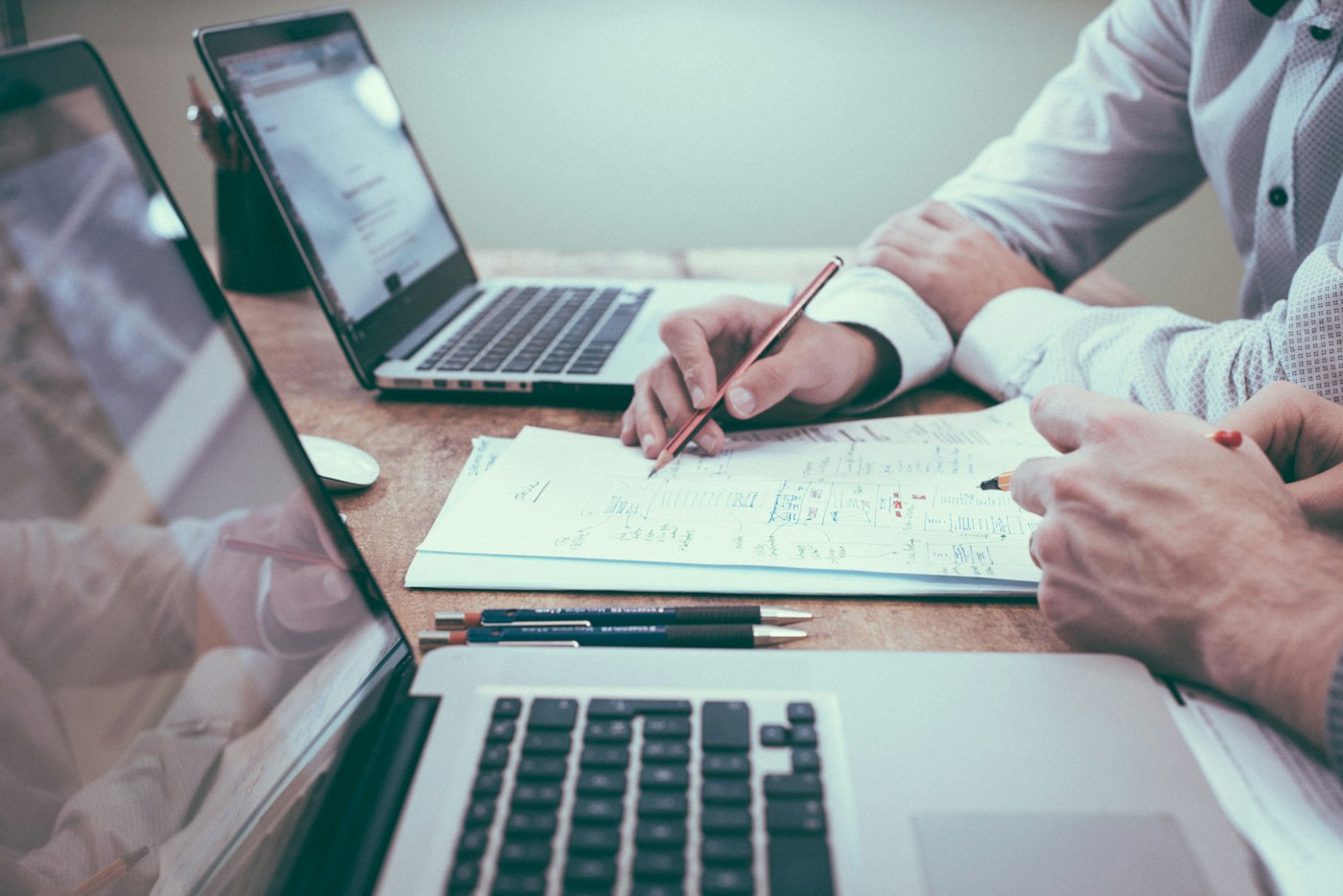 Market research and commercial planning with reports and laptops